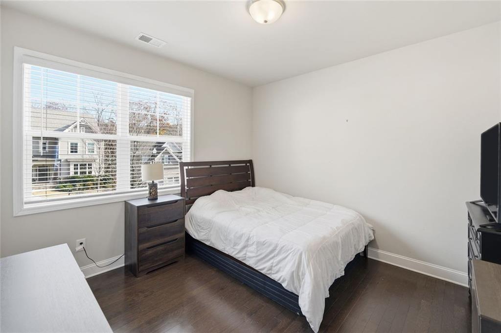 123 Longleaf Drive Canton, GA 30114 - Photo 25 of 39 a bed sitting in a bedroom next to a window