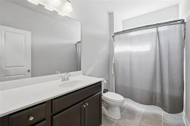 a bathroom with a sink a toilet a mirror and shower