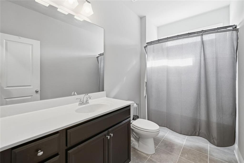 123 Longleaf Drive Canton, GA 30114 - Photo 26 of 39 a bathroom with a sink a toilet a mirror and shower