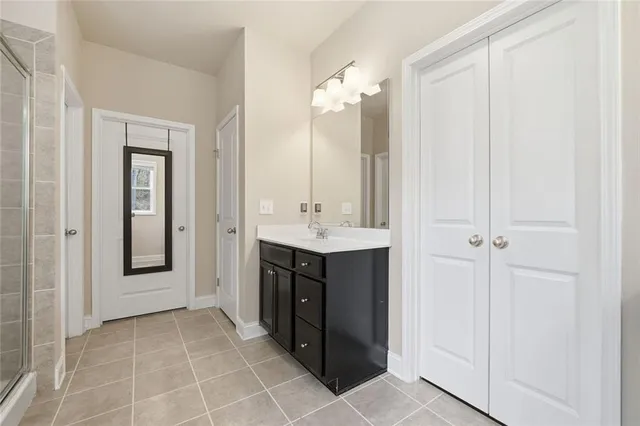 a bathroom with a sink vanity and a mirror