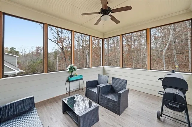 a living room with furniture and a floor to ceiling window