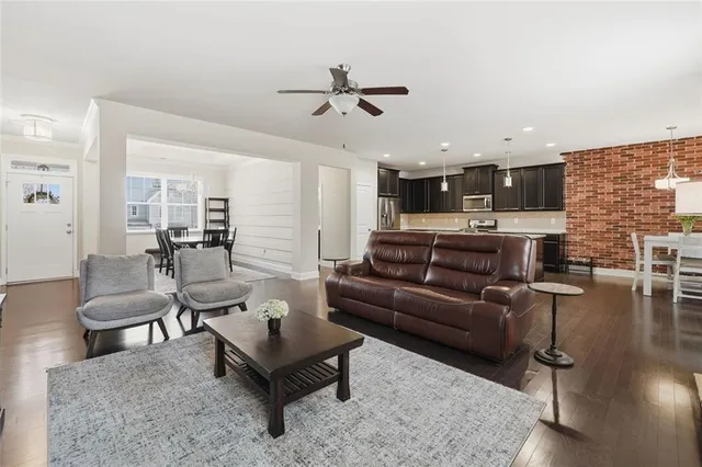 a living room with furniture and kitchen view