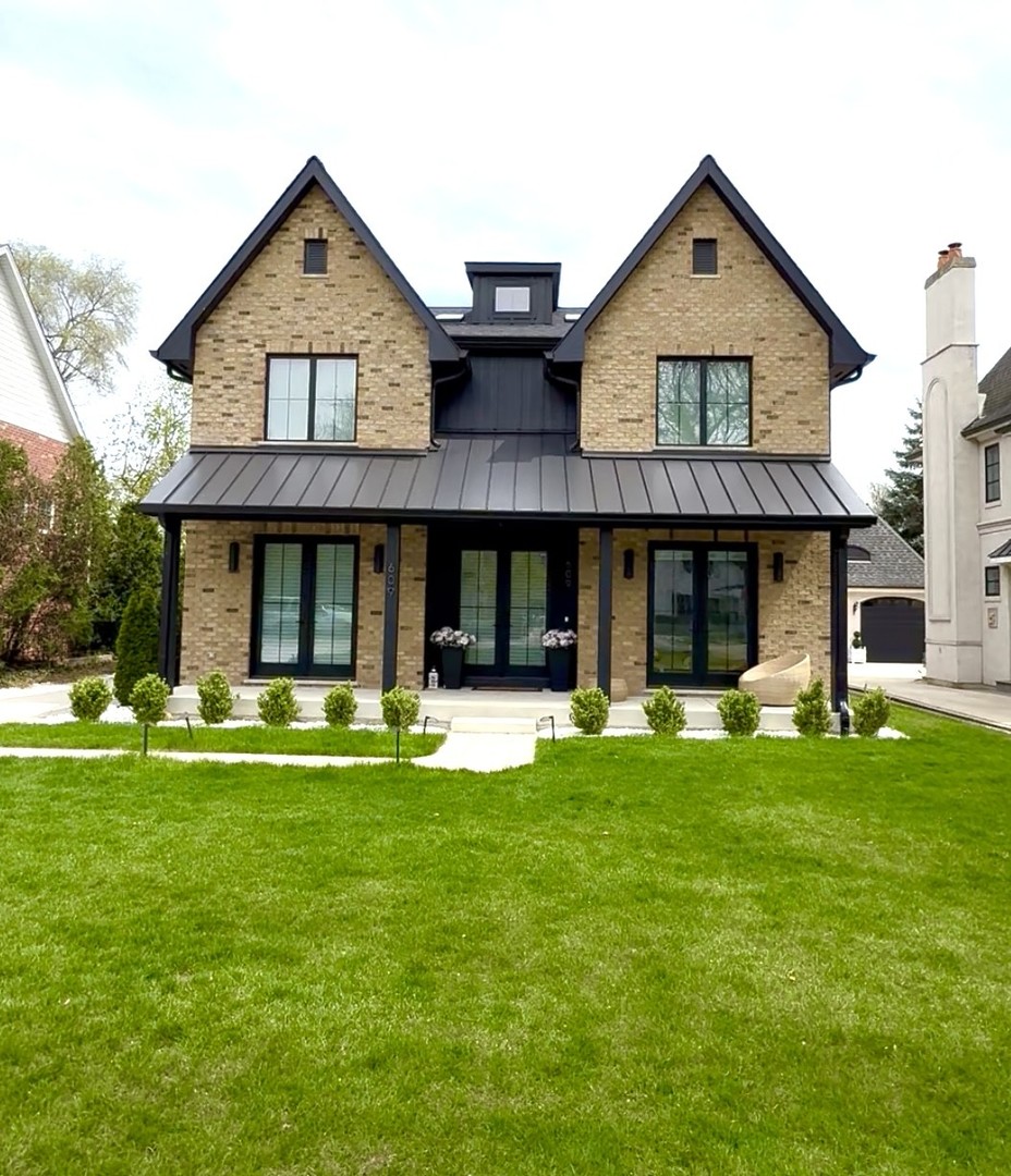a front view of a house with a garden and porch