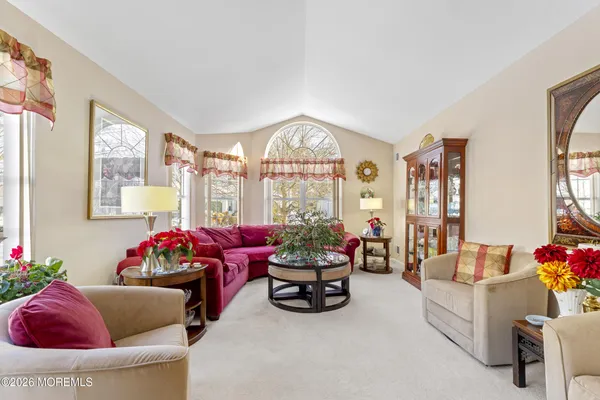 a view of a dining room with furniture and a chandelier