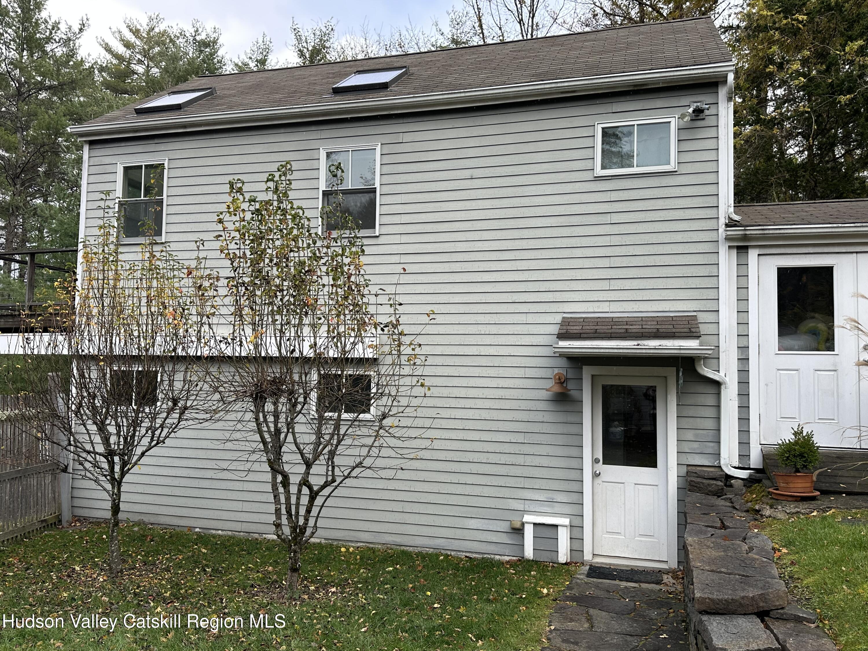 85 Broadview Road, Unit STUDIO Woodstock, NY 12498 - Photo 2 of 10 a front view of a house with a yard