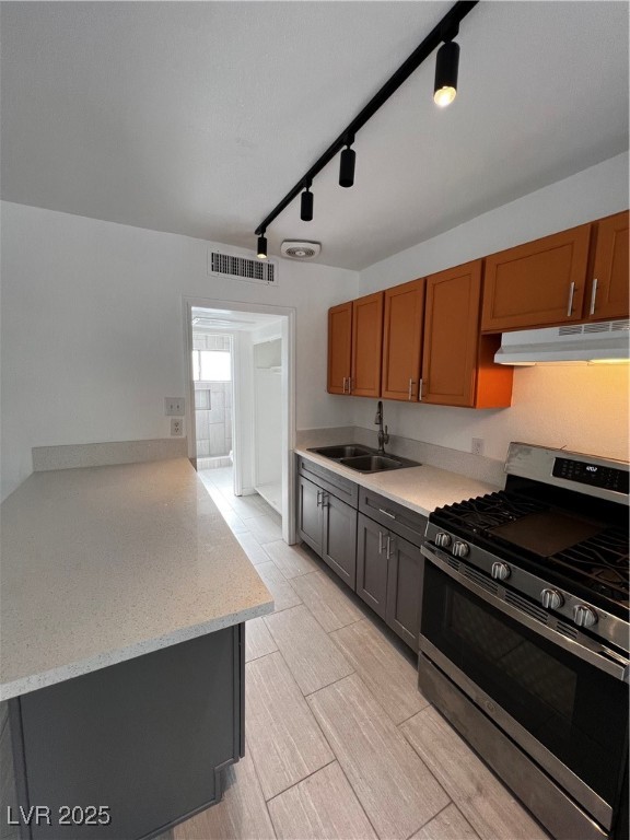 308 West Cincinnati Avenue, Unit 8 Las Vegas, NV 89102 - Photo 6 of 9 Kitchen with stove, range hood, a sink, visible vents, and brown cabinets