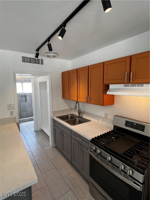 308 West Cincinnati Avenue, Unit 8 Las Vegas, NV 89102 - Photo 7 of 9 Kitchen with stove, range hood, a textured ceiling, a sink, and visible vents