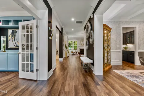 a view of a hallway with wooden floor and entryway