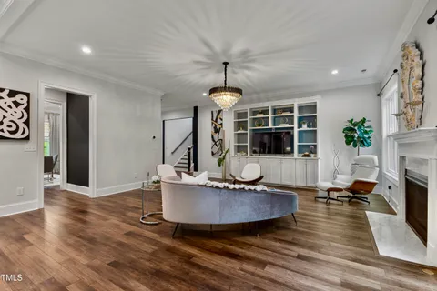 a living room with furniture a window and a fireplace