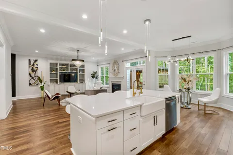 a kitchen with stainless steel appliances kitchen island granite countertop a sink stove and refrigerator