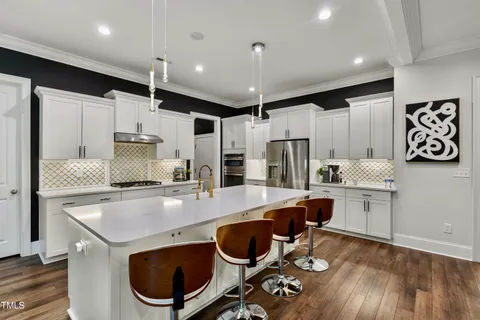 a kitchen with stainless steel appliances granite countertop a refrigerator and a sink
