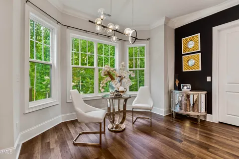 a spacious bedroom with a bed and wooden floor