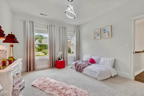 a living room with furniture a potted plant and a large window