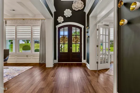 a view of a hallway view with wooden floor and living room