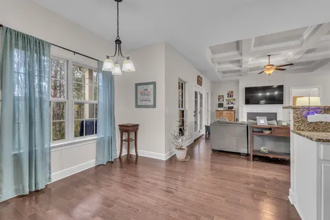 a view of a livingroom with furniture wooden floor and a window