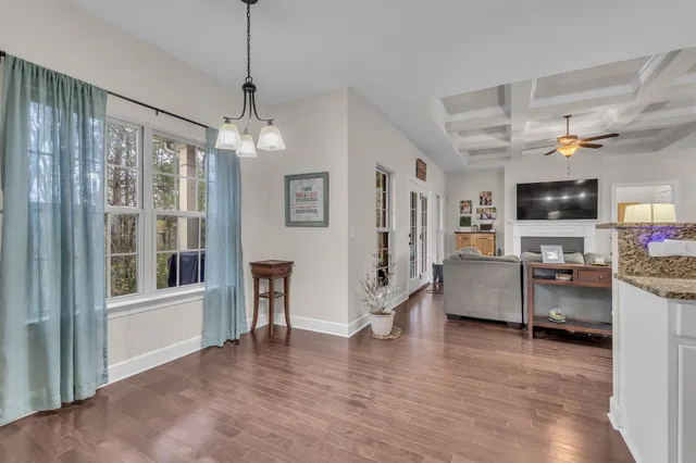 a view of a livingroom with furniture wooden floor and a window