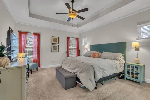 a spacious bedroom with a bed and a chandelier