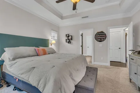 a spacious bedroom with a bed and cabinets