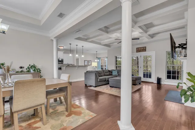 a view of a dining room with furniture wooden floor and a chandelier