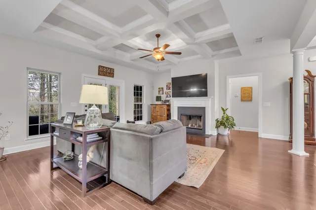 a living room with furniture a fireplace and a flat screen tv