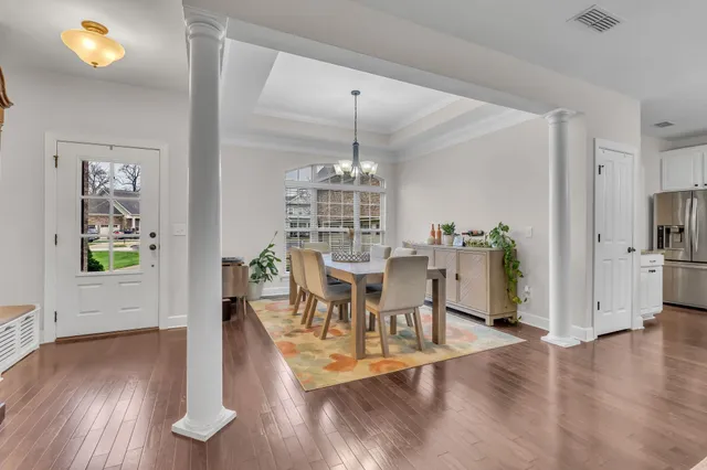 a view of a dining room with furniture window and wooden floor