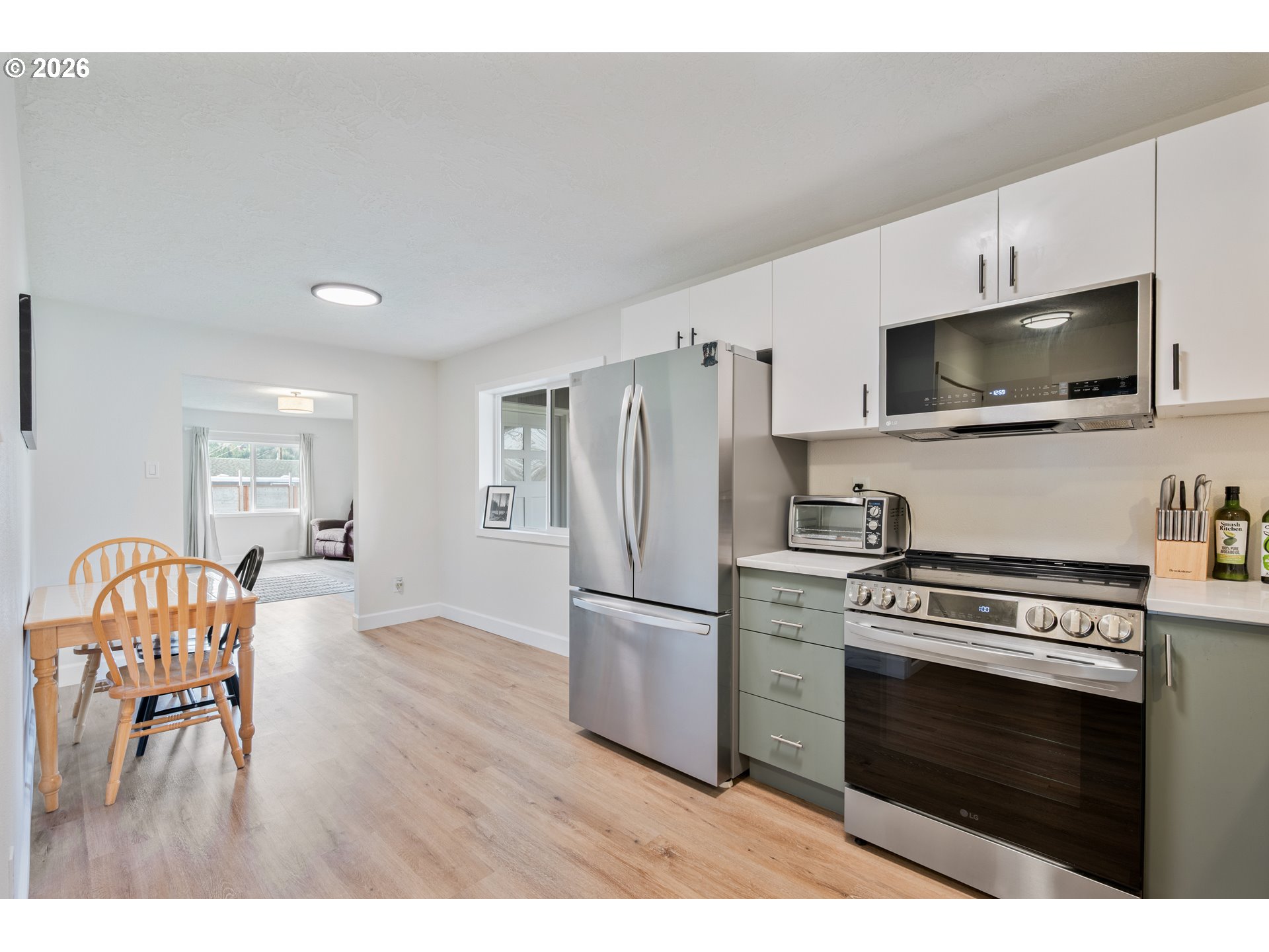 1239 Rose Valley Road Kelso, WA 98626 - Photo 46 of 48 a kitchen with stainless steel appliances a stove a sink and a refrigerator