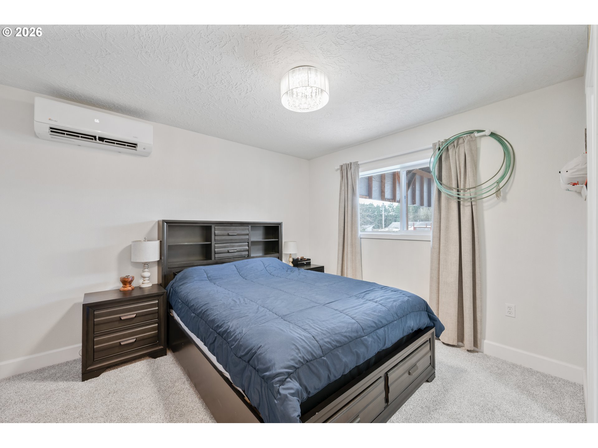 1239 Rose Valley Road Kelso, WA 98626 - Photo 47 of 48 a bedroom with a bed and a chandelier