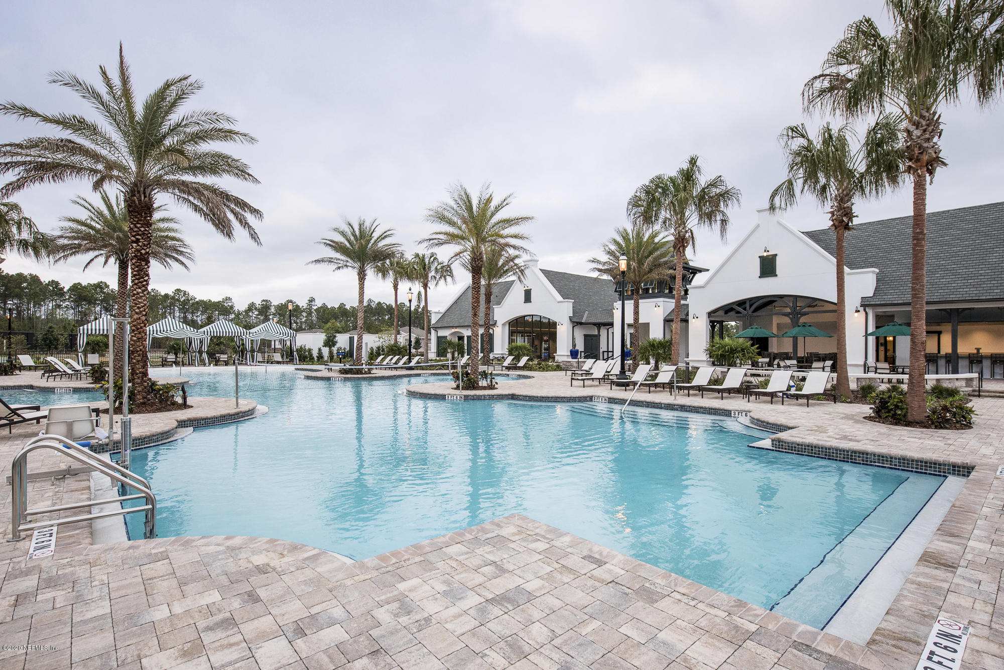 51 Seamount Way St. Augustine, FL 32092 - Photo 19 of 24 a view of a swimming pool with a lounge chair and palm trees