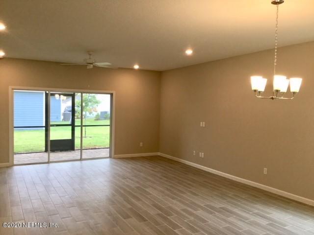 51 Seamount Way St. Augustine, FL 32092 - Photo 2 of 24 a view of an empty room with wooden floor and a window