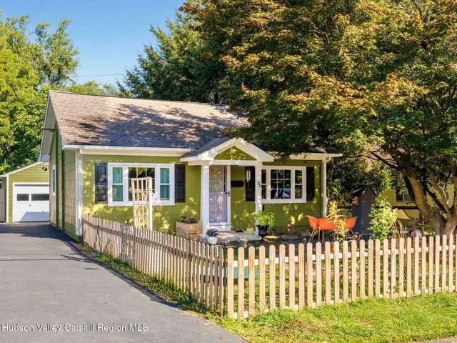 a front view of house with wooden fence