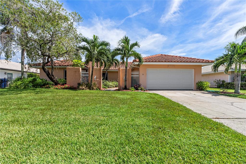2044 Montana Avenue Northeast St. Petersburg, FL 33703 - Photo 1 of 53 a front view of house with yard and garage