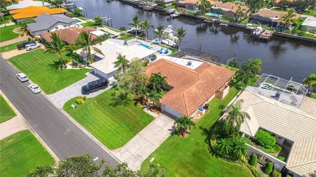 an aerial view of residential houses with swimming pool and outdoor space
