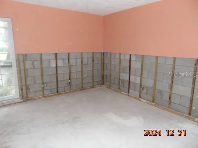 an entrance to room with wooden floor