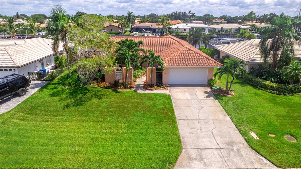 2044 Montana Avenue Northeast St. Petersburg, FL 33703 - Photo 4 of 53 a aerial view of a house with a yard and trees