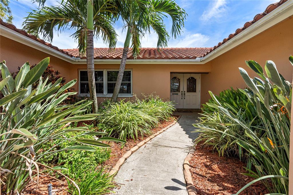 2044 Montana Avenue Northeast St. Petersburg, FL 33703 - Photo 6 of 53 a front view of a house with a plant