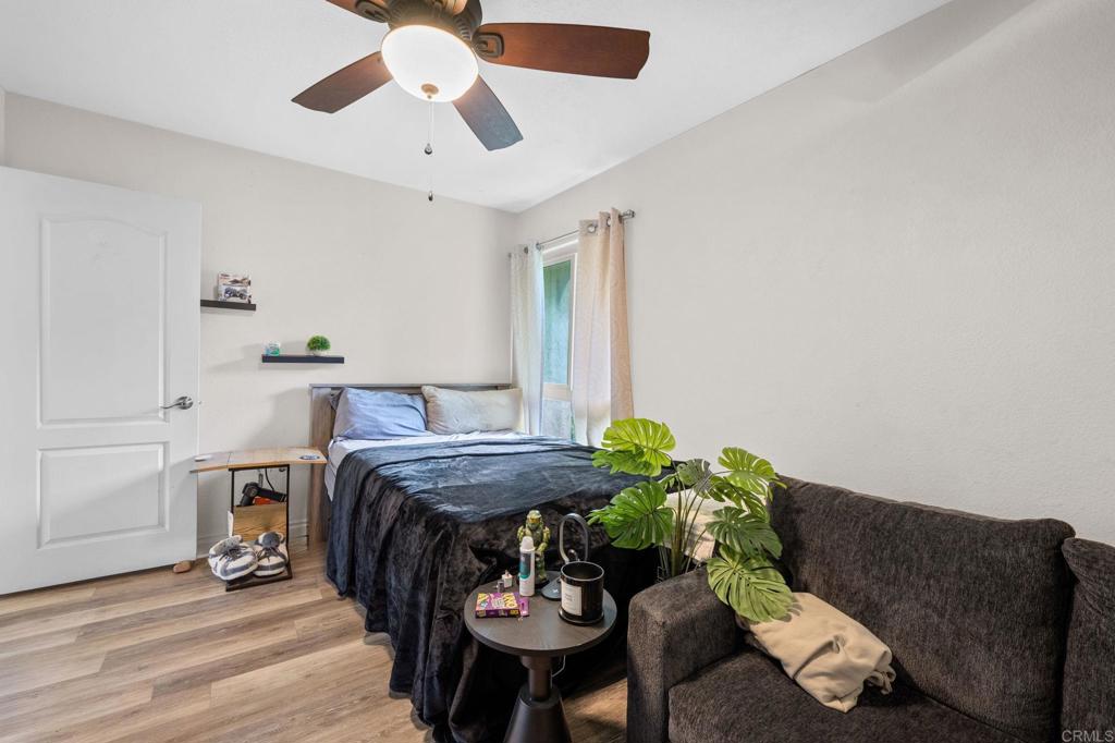 3470 Peach Tree Way Oceanside, CA 92058 - Photo 11 of 21 a bed room with furniture and a chandelier