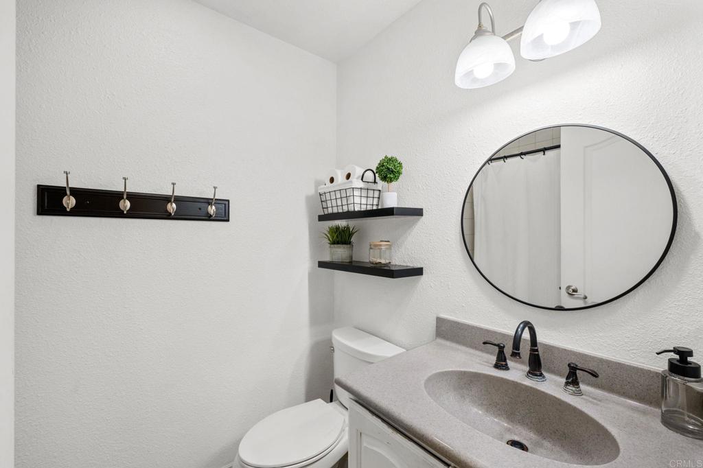 3470 Peach Tree Way Oceanside, CA 92058 - Photo 14 of 21 a bathroom with a toilet sink and mirror