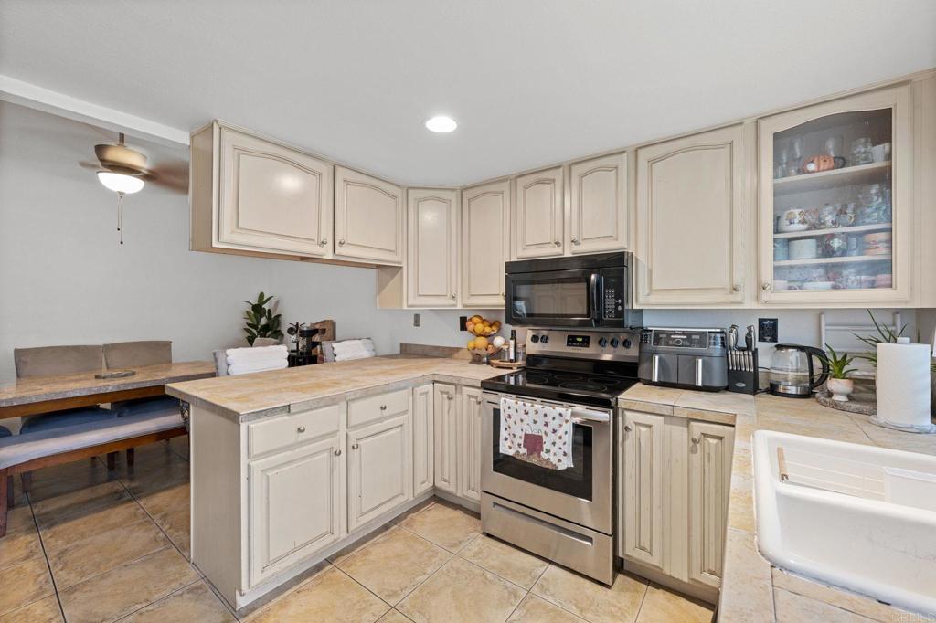 3470 Peach Tree Way Oceanside, CA 92058 - Photo 4 of 21 a kitchen with white cabinets and white appliances