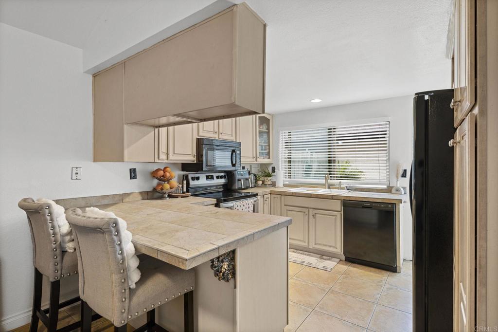 3470 Peach Tree Way Oceanside, CA 92058 - Photo 5 of 21 a kitchen with a stove a sink and a refrigerator