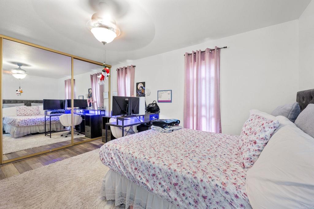 3470 Peach Tree Way Oceanside, CA 92058 - Photo 7 of 21 a bed room with a bed and a chandelier