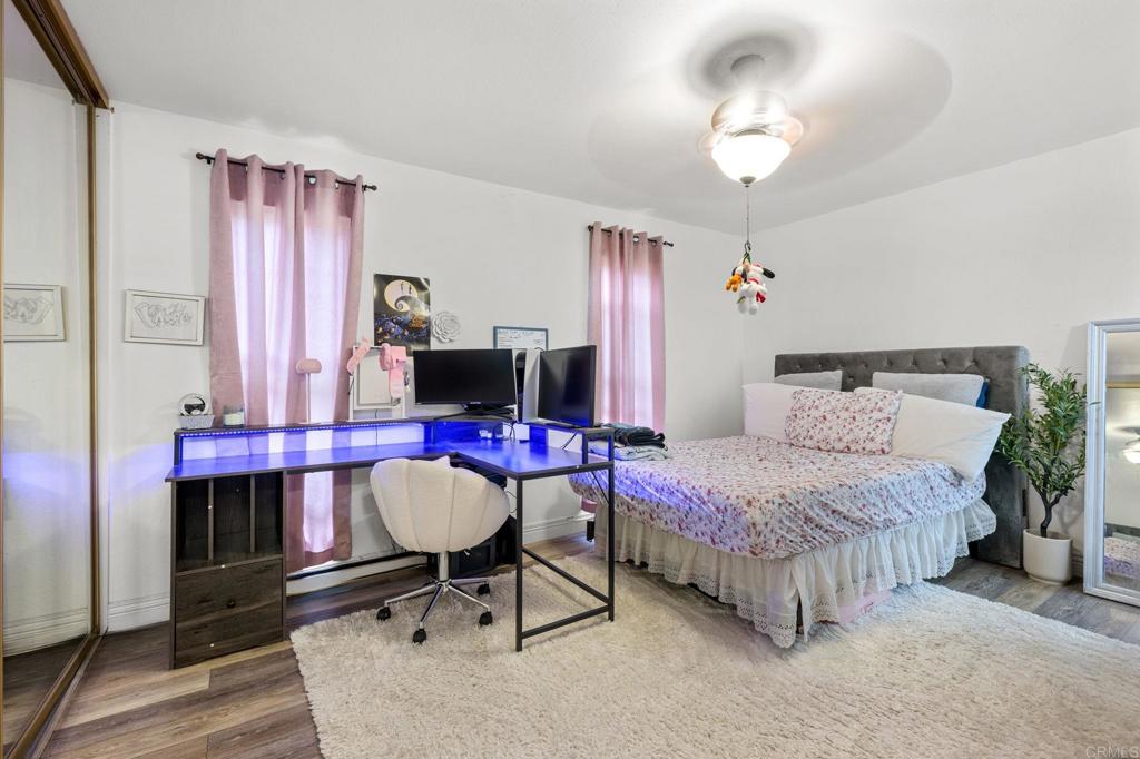 3470 Peach Tree Way Oceanside, CA 92058 - Photo 8 of 21 a bedroom with a bed and a chandelier