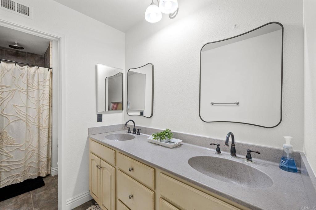3470 Peach Tree Way Oceanside, CA 92058 - Photo 9 of 21 a bathroom with double vanity sinks and a mirror
