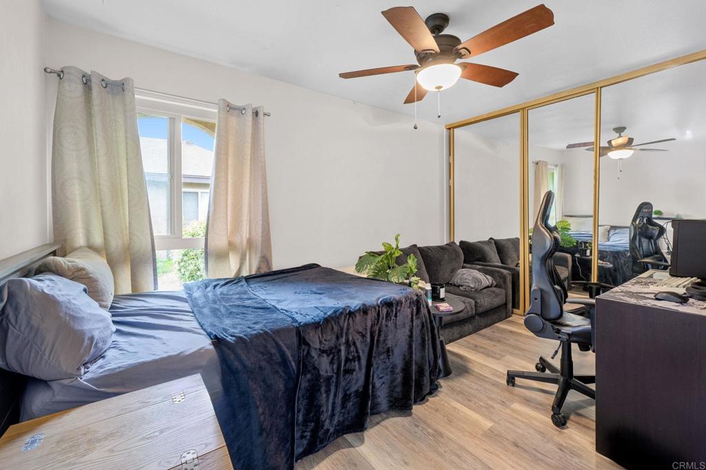 3470 Peach Tree Way Oceanside, CA 92058 - Photo 10 of 21 a bedroom with a bed a large window and couch