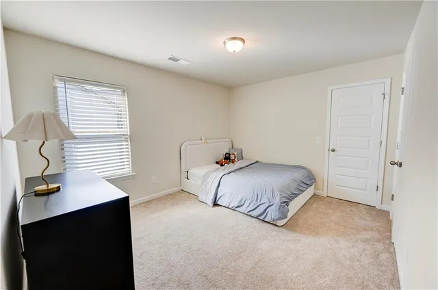 a bedroom with a bed and a desk