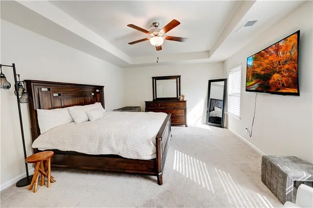 a bedroom with a large bed a desk and chair