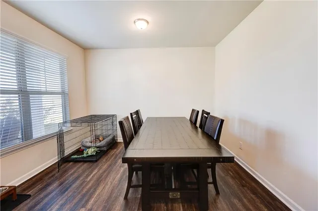 a view of a room with furniture and wooden floor