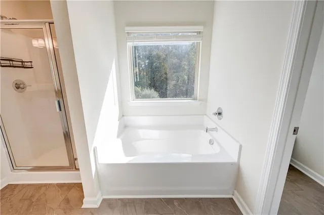 a white bath tub sitting next to a window