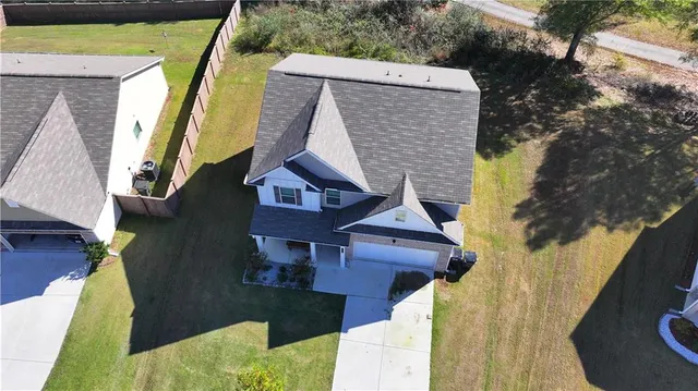 an aerial view of houses with yard