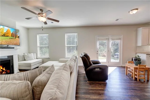 a living room with furniture fireplace and flat screen tv