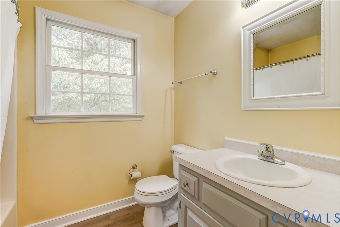 3820 Mt Pleasant Road Providence Forge, VA 23140 - Photo 21 of 40 a bathroom with a sink mirror vanity and a toilet